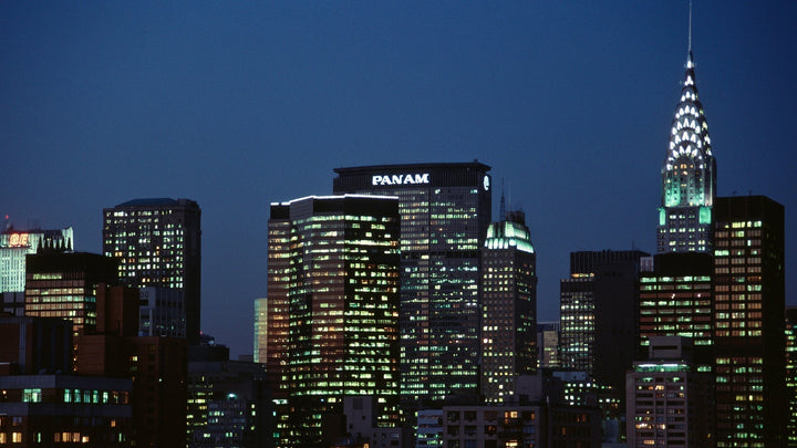 Pan Am Building illuminated at night alongside the Chrysler Building in New York City skyline